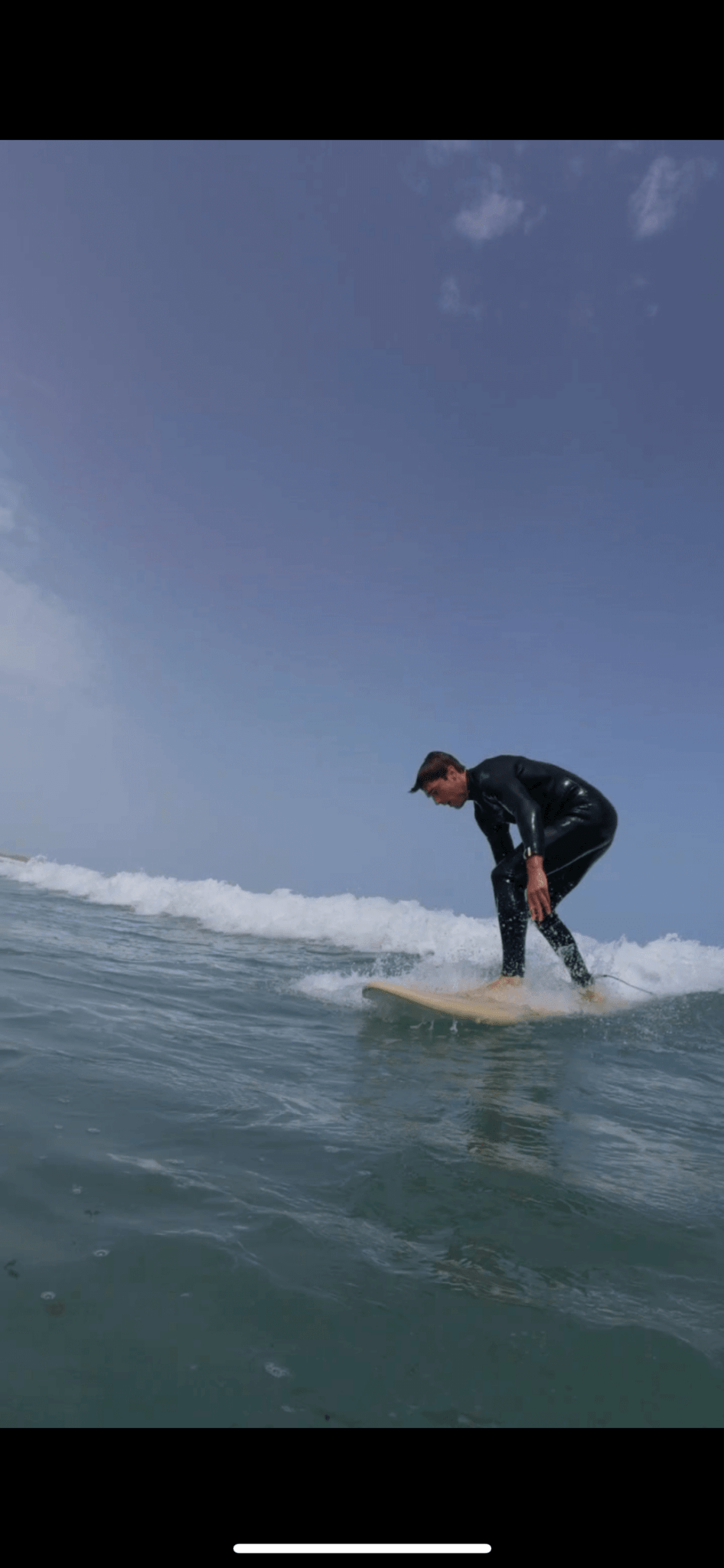Surfer riding a wave during a 1-day surf course at Famara Beach, Lanzarote