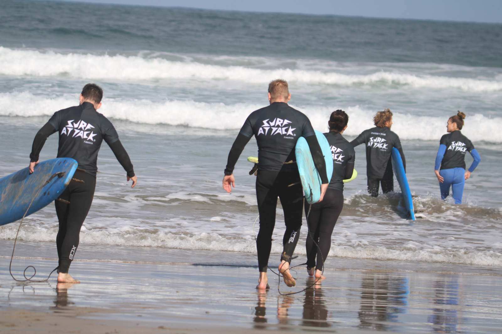 Surfer taking a lesson on a wave at Famara Beach during a 1-day surf course