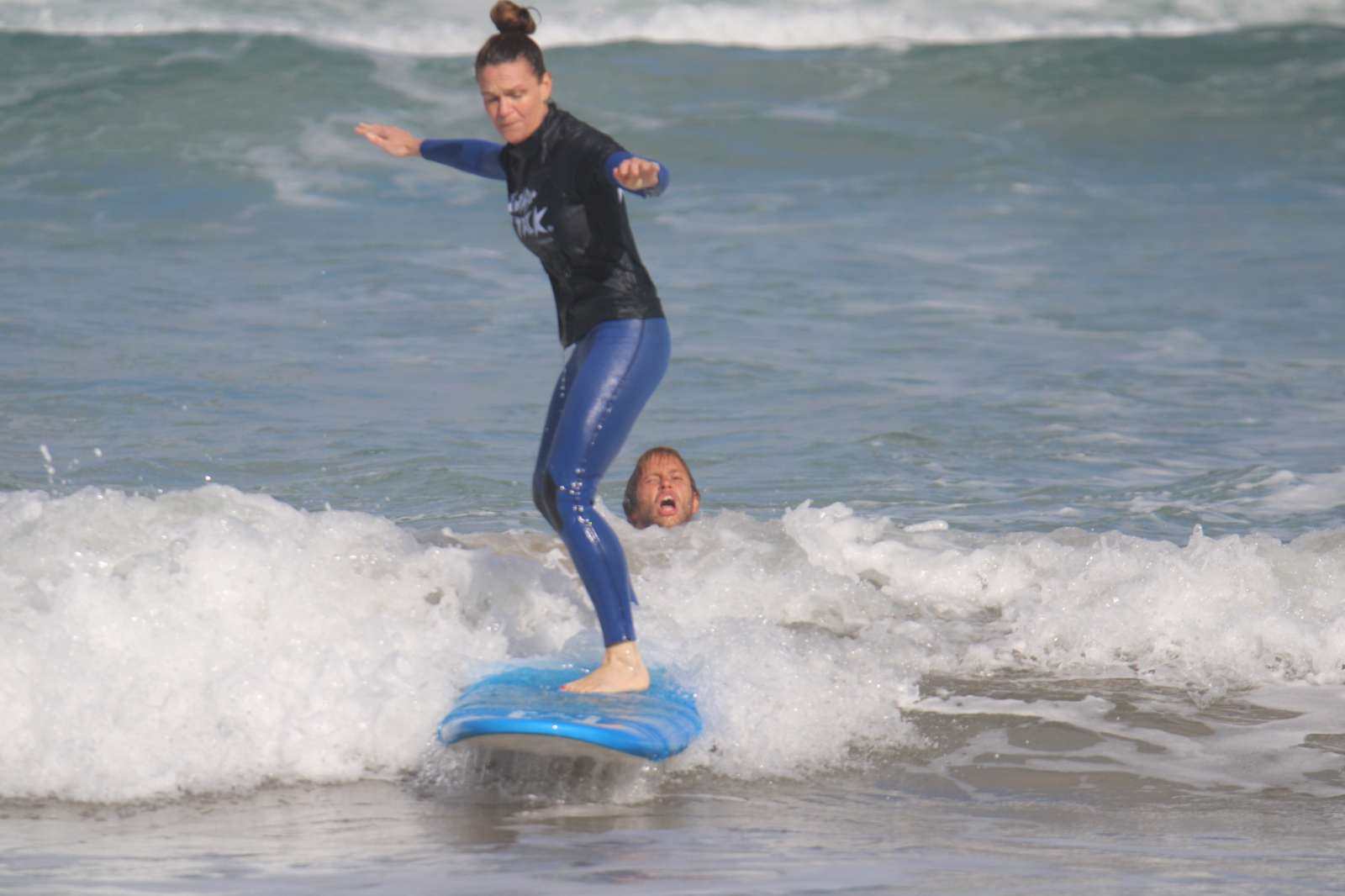 Surfer receiving one-on-one private surf lesson from instructor on Lanzarote's Famara Beach waves