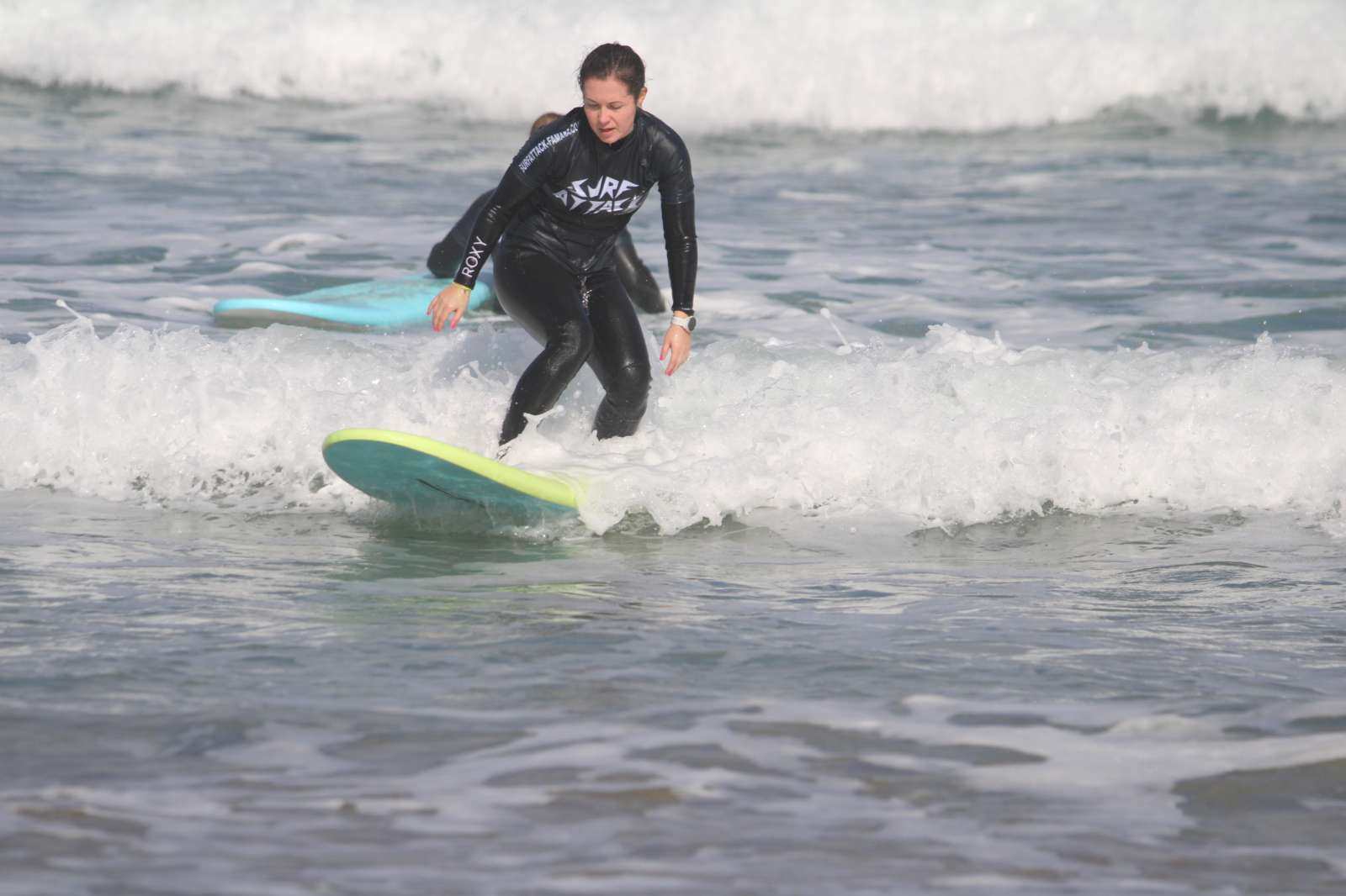 Surf instructor teaching small group during 1-day surf course at Famara Beach, Lanzarote