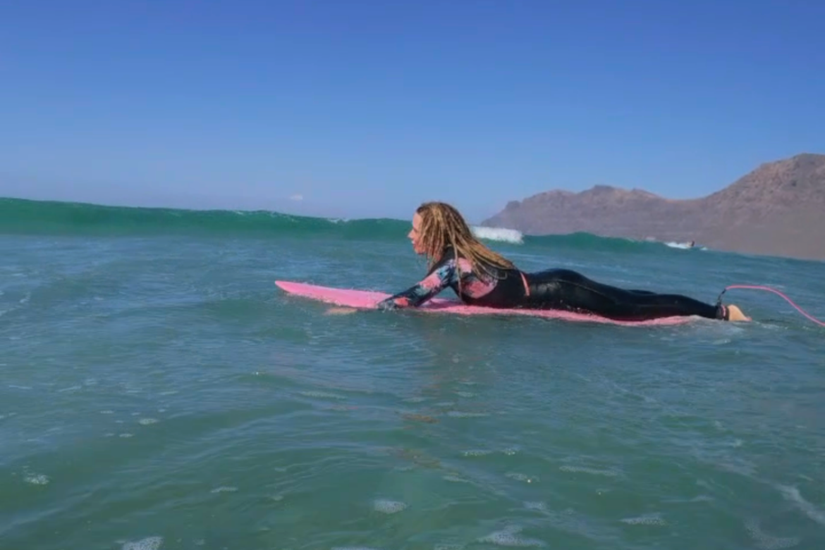 Surf Attack student riding a clean wave at Playa de Famara Lanzarote during surf lesson
