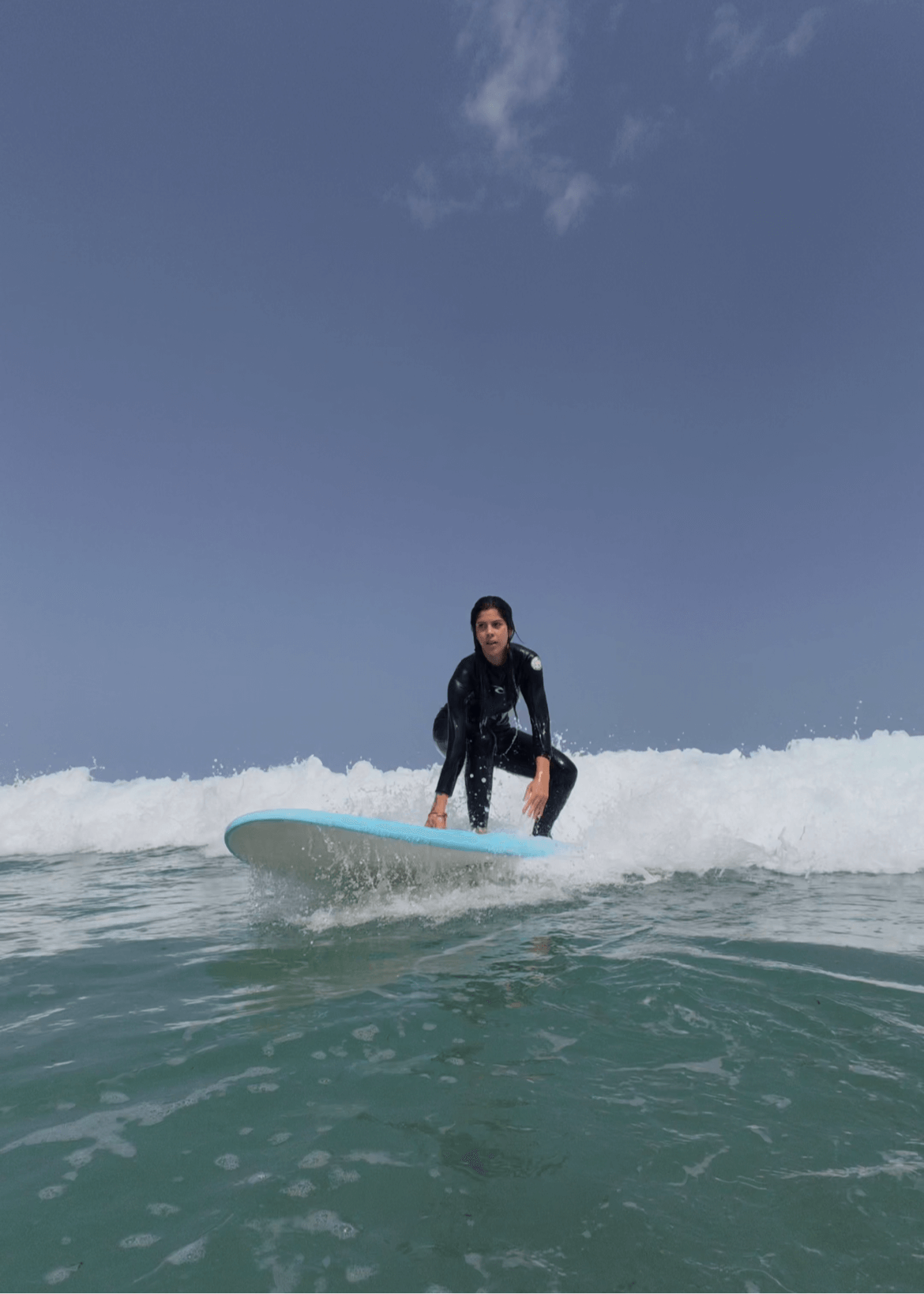 Surfer learning to ride waves during 1-day surf course at Famara Beach in Lanzarote